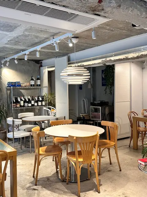 木のテーブルと椅子、ワイン棚が並ぶヒッポブランチハウスの店内 — 100坪超のブランチグルメ空間